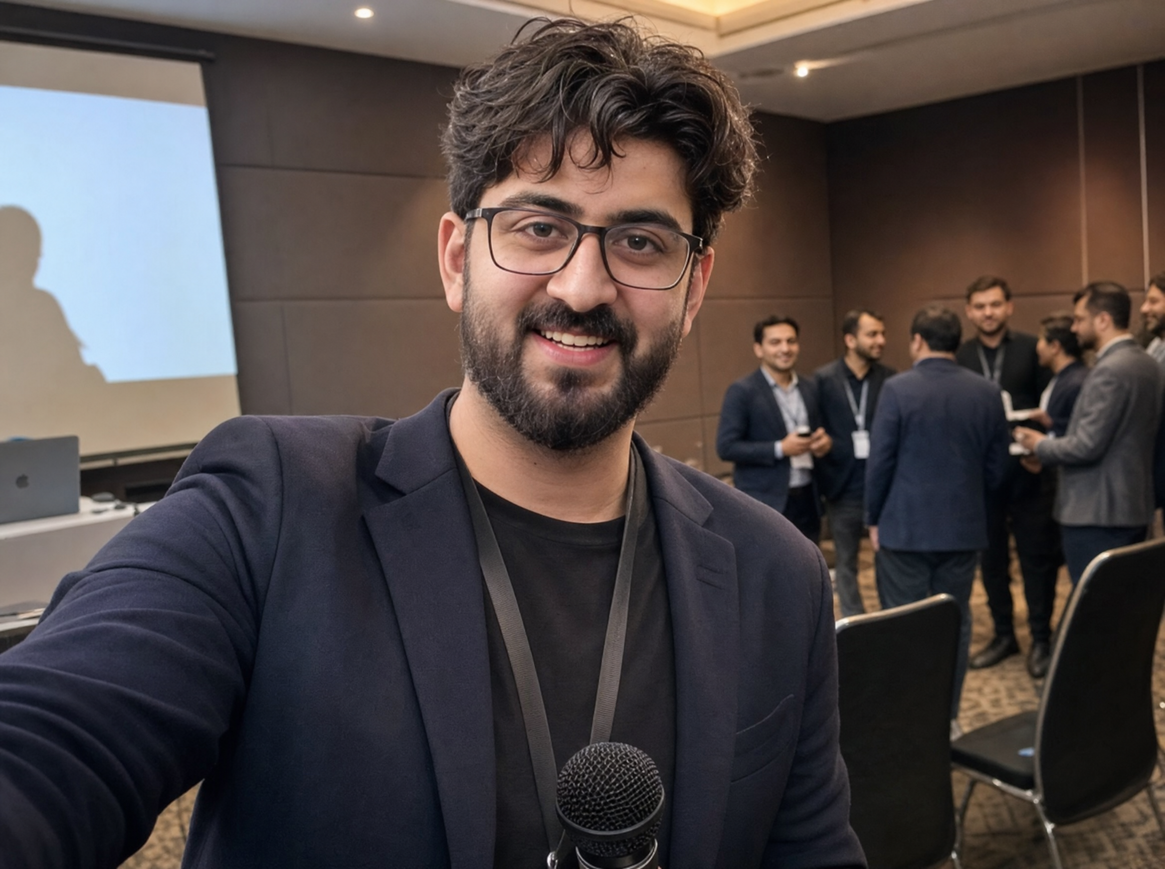 Abdullah at a live business event, mic in hand